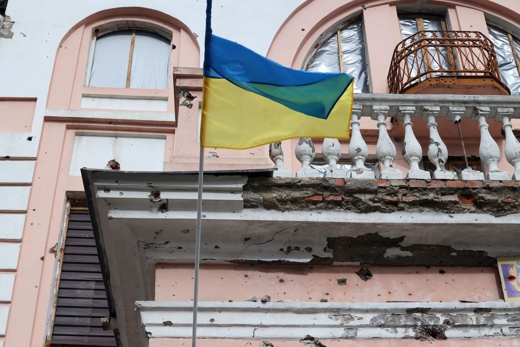 A blue and yellow flag on a balcony

Description automatically generated