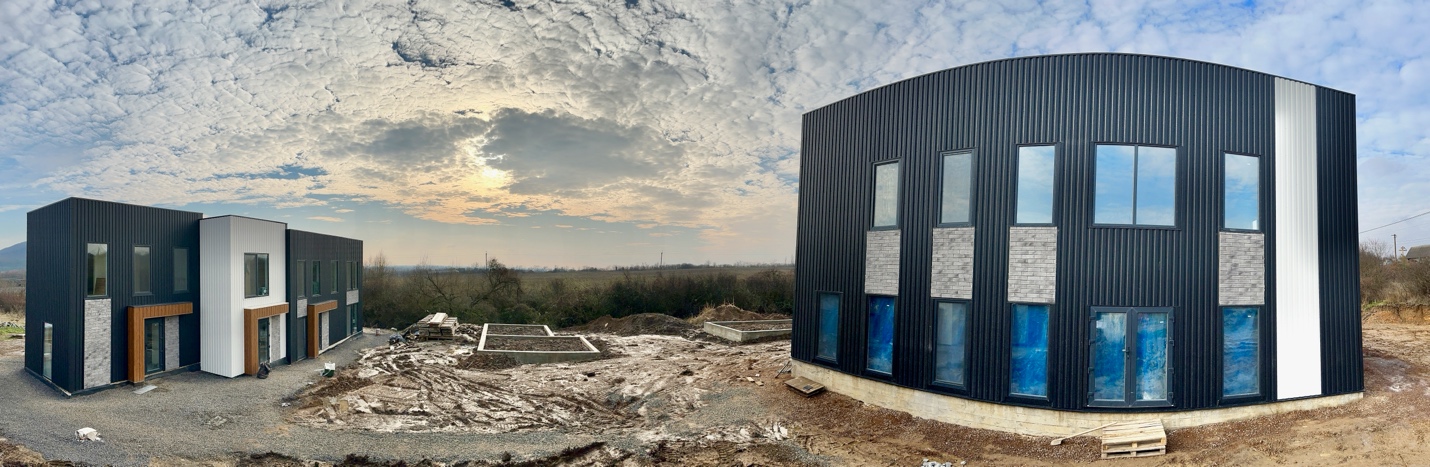 A building under construction with a cloudy sky

Description automatically generated