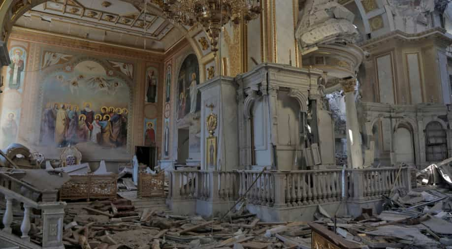 A destroyed church with many pieces of debris

Description automatically generated