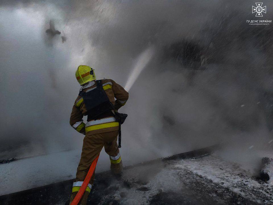 A firefighter spraying water on a fire

Description automatically generated