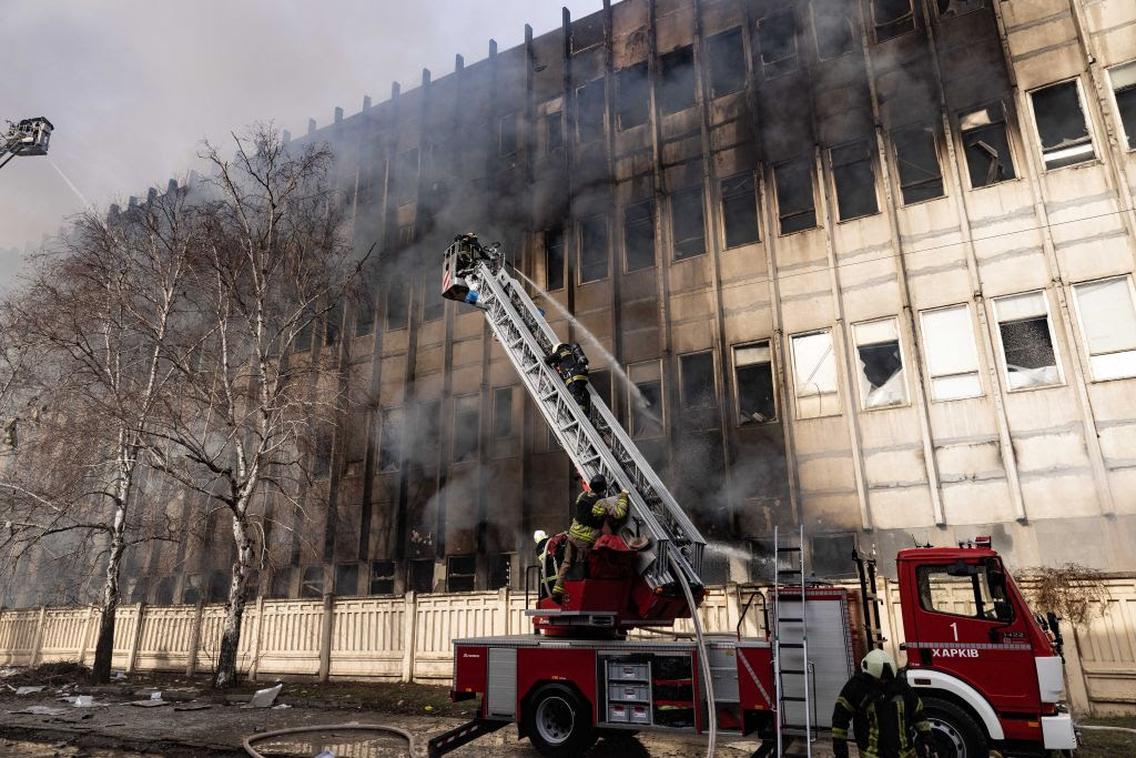 A firemen on a ladder on a fire

Description automatically generated