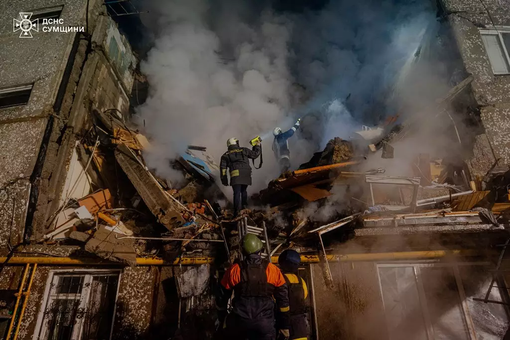 A group of firefighters standing in front of a building that has smoke coming out of it

Description automatically generated