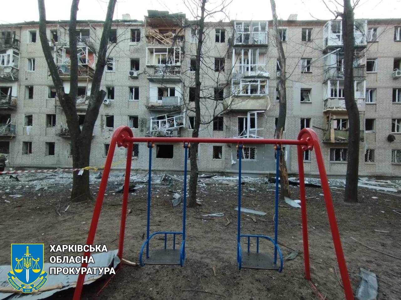 A playground in front of a building

Description automatically generated