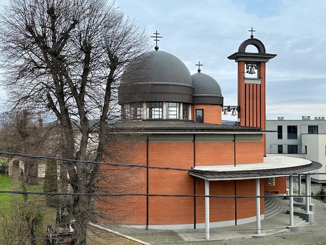 A building with a dome and a bell tower

Description automatically generated