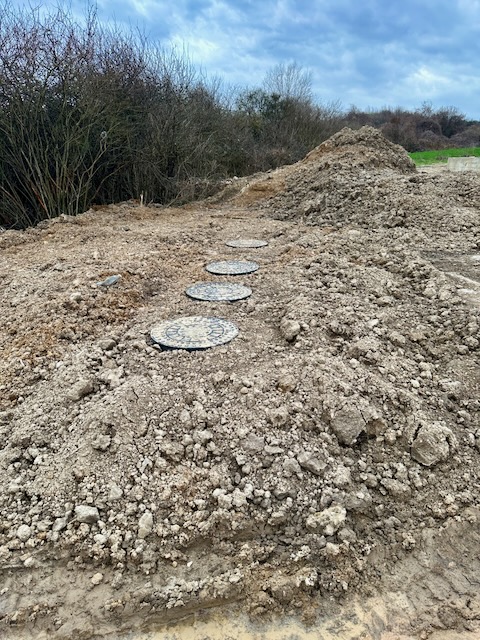 A path made of round concrete plates on a dirt hill

Description automatically generated with medium confidence