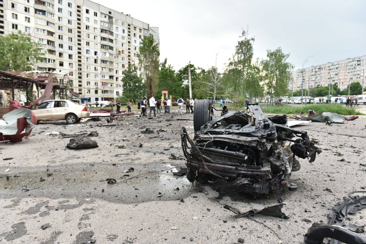 A burned out car on the street

Description automatically generated