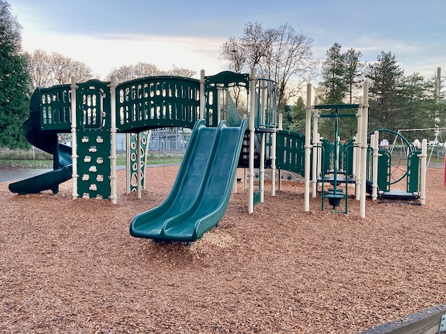 A playground with a slide

Description automatically generated