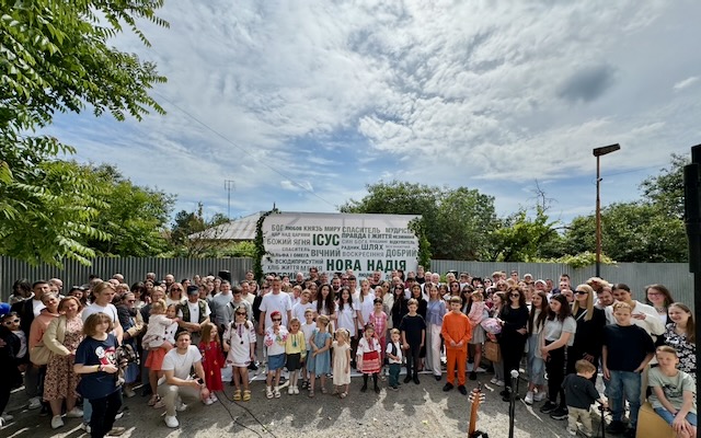 A group of people posing for a photo

Description automatically generated