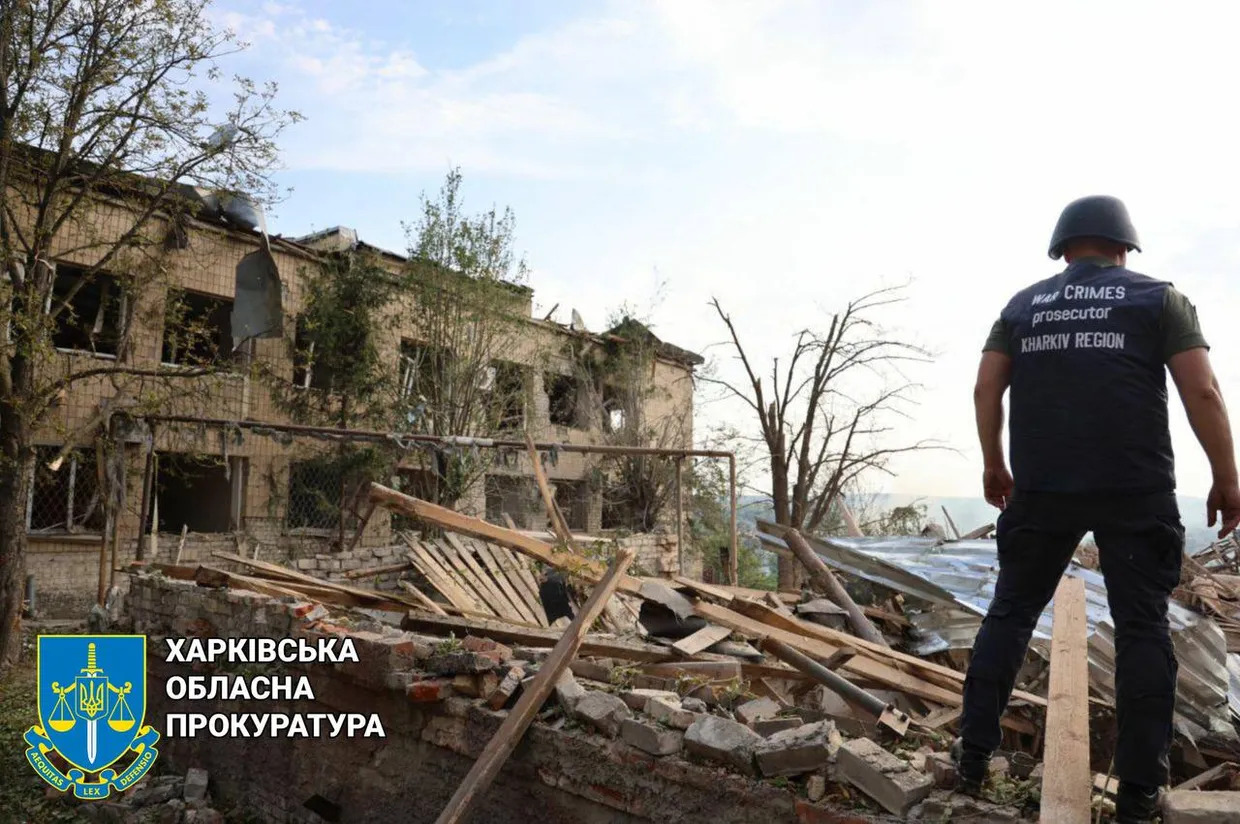 a statue of a man in front of a damaged building