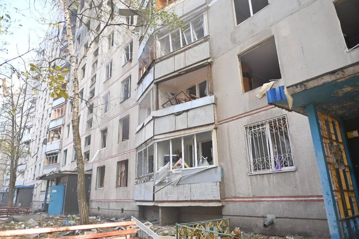 a statue of a man in front of a damaged building