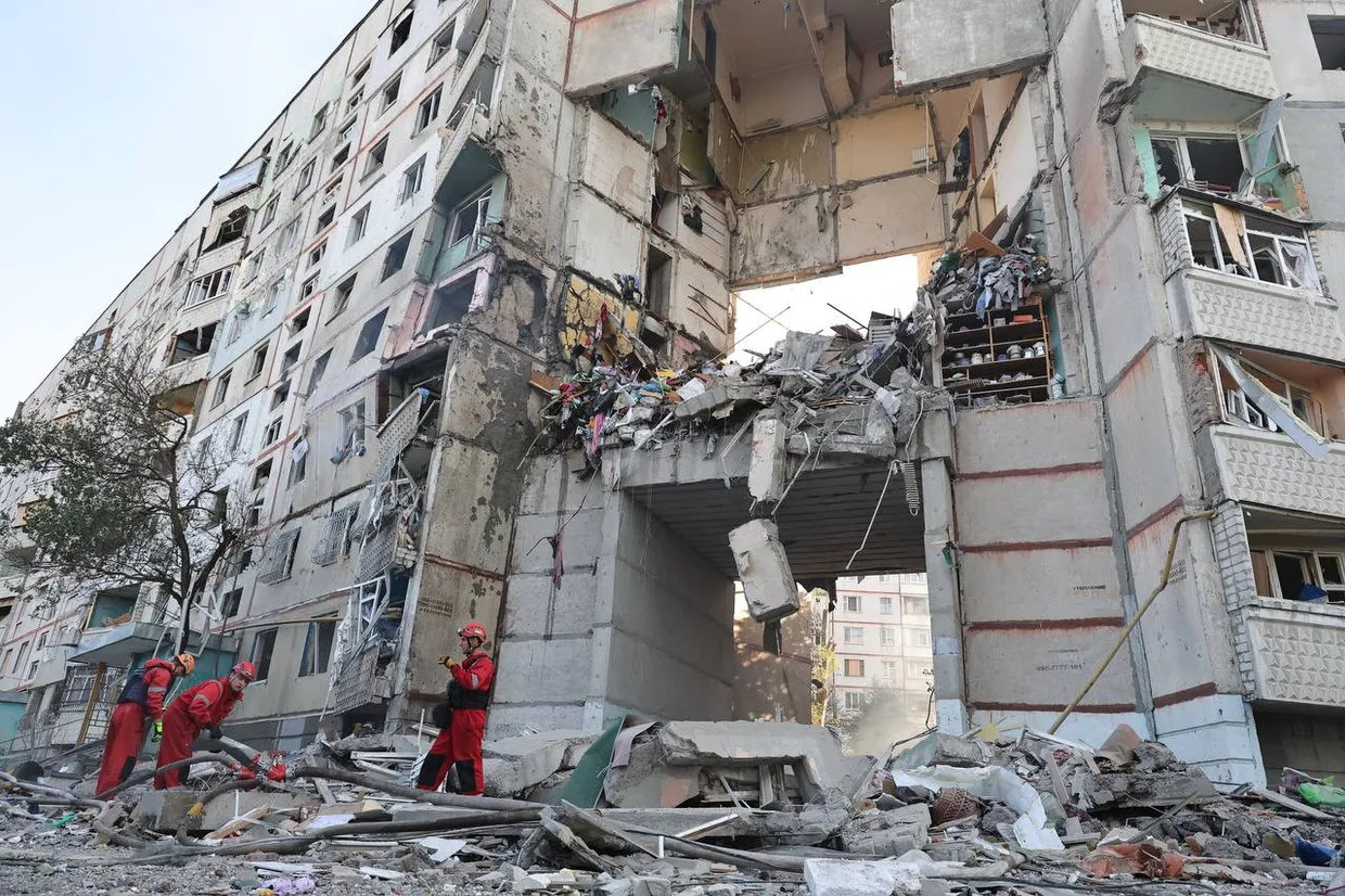 a statue of a man in front of a damaged building