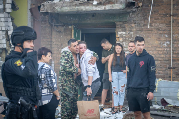 a statue of a man in front of a damaged building