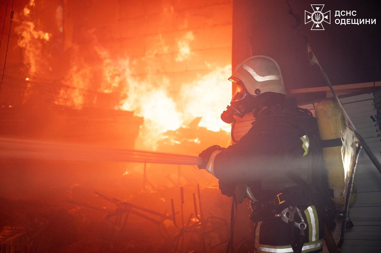 A firefighter putting out a fire

Description automatically generated