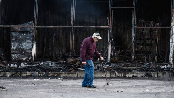 a statue of a man in front of a damaged building