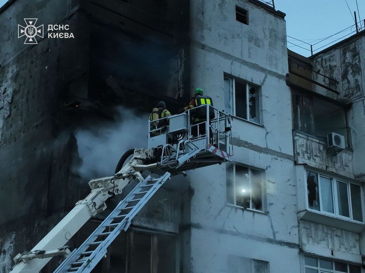 A firemen on a ladder on a building

Description automatically generated