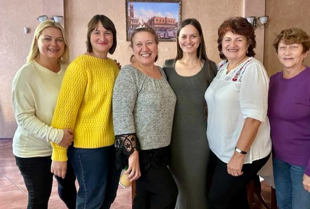 A group of women posing for a photo

Description automatically generated