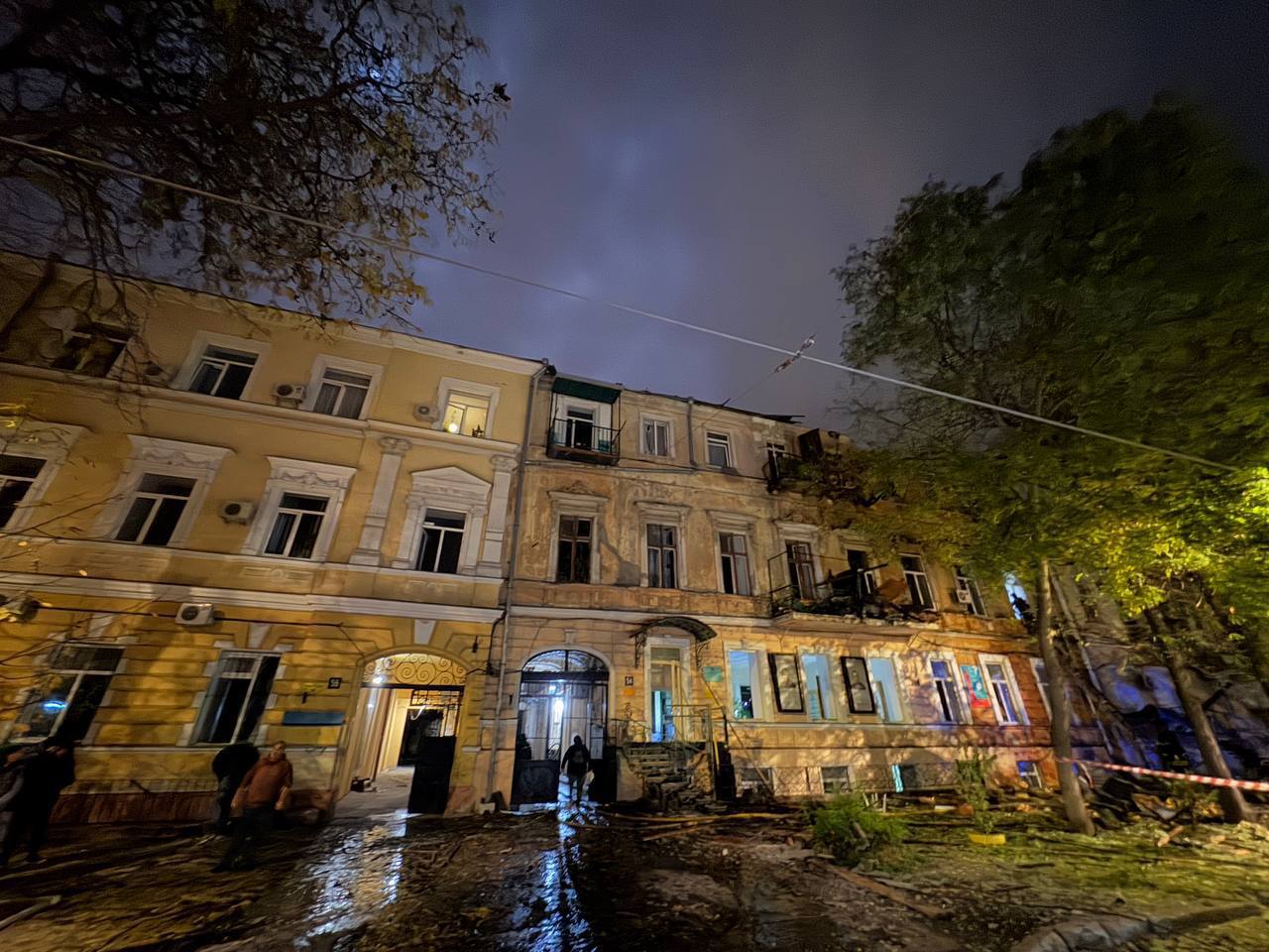 an apartment building at night with smoke coming out of the window