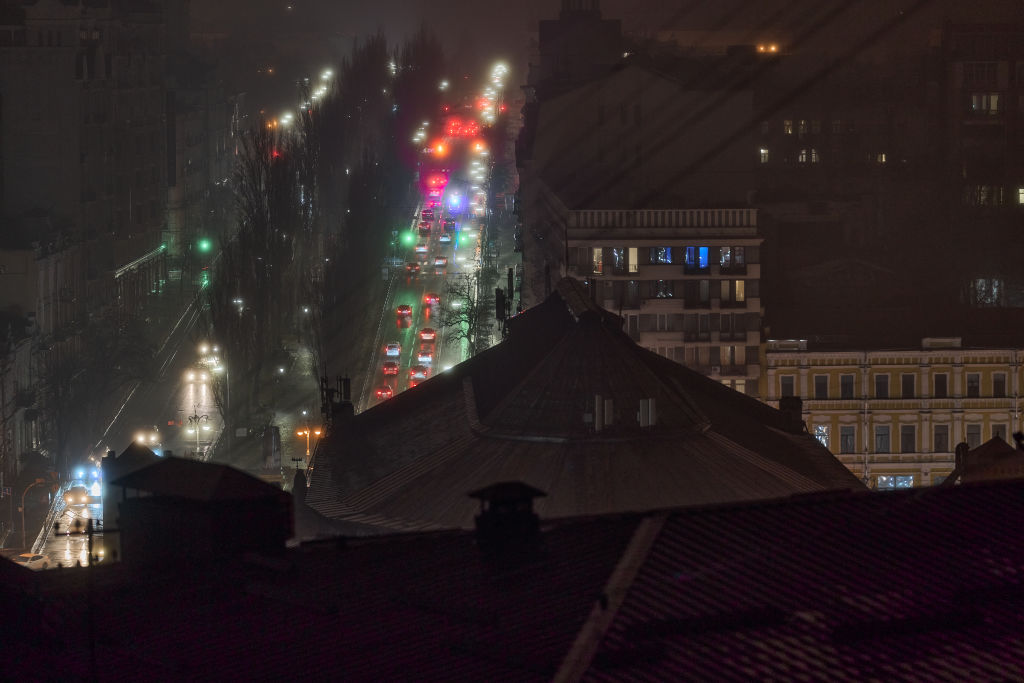 an apartment building at night with smoke coming out of the window