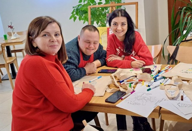 A group of people sitting at a table

Description automatically generated