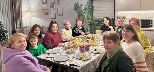 A group of women sitting around a table

Description automatically generated