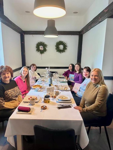 A group of women sitting at a table

Description automatically generated