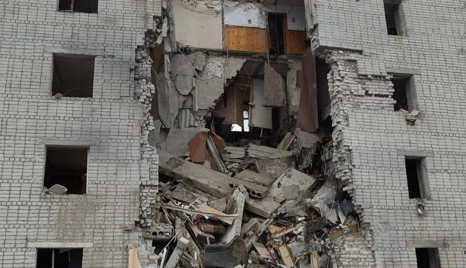 an apartment building at night with smoke coming out of the window