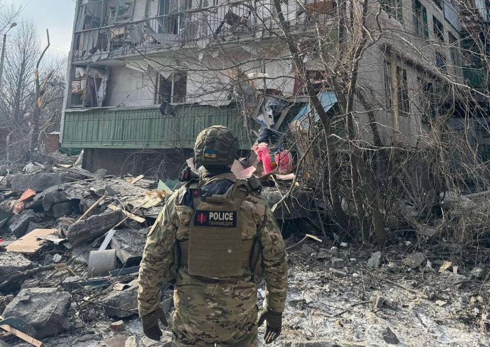 A person in uniform standing in front of a destroyed building

AI-generated content may be incorrect.