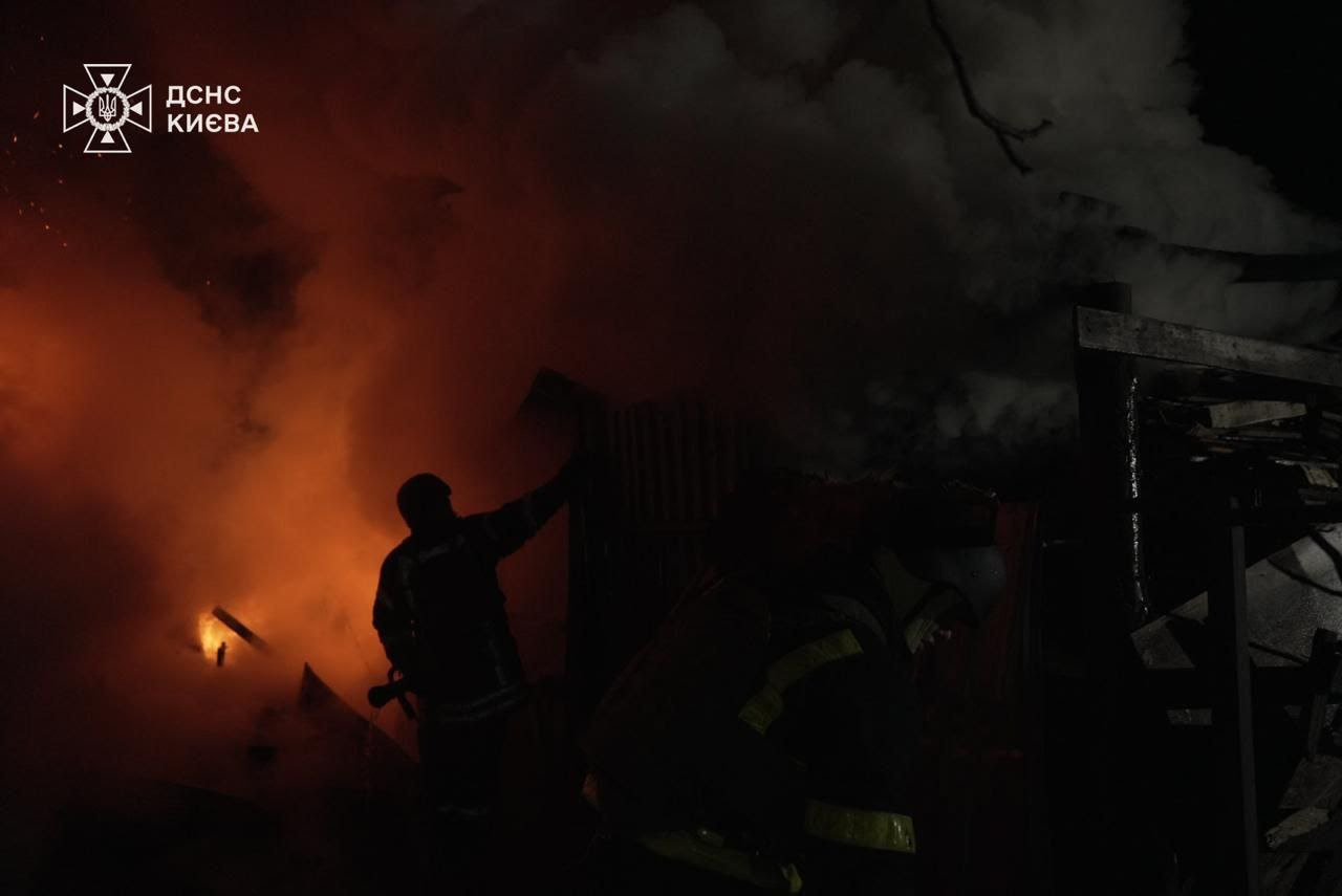 an apartment building at night with smoke coming out of the window