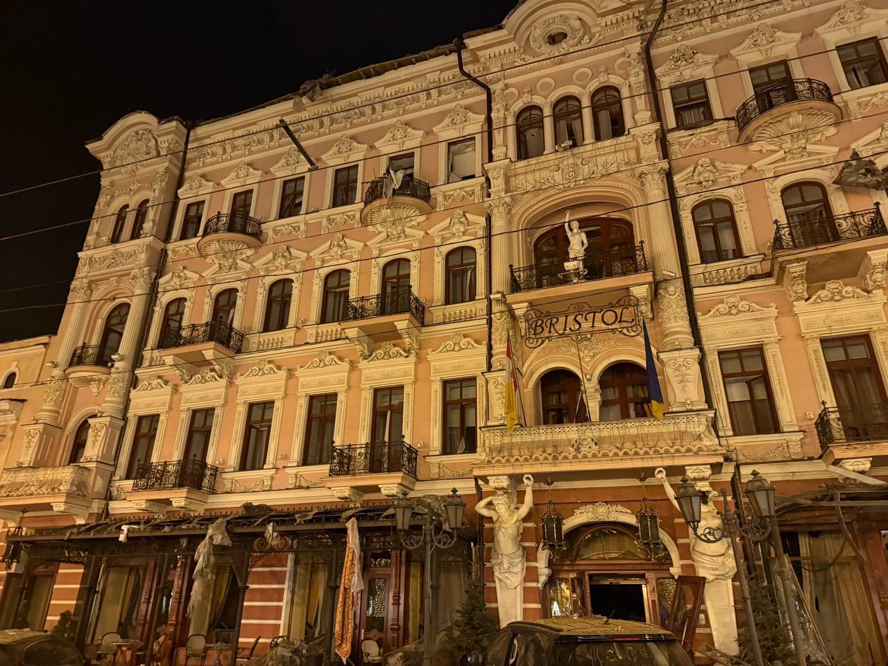 an apartment building at night with smoke coming out of the window