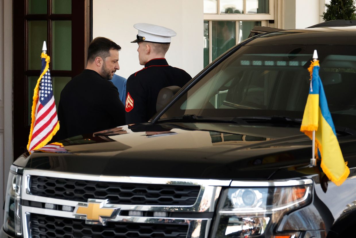 A couple of men talking to a black car

AI-generated content may be incorrect.