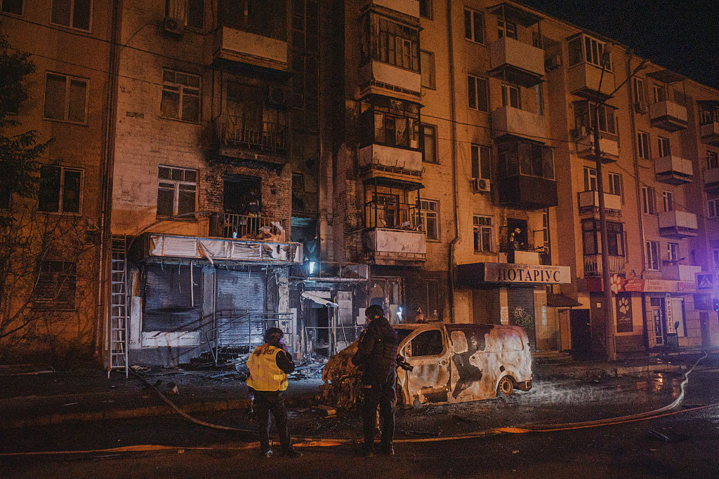 an apartment building at night with smoke coming out of the window