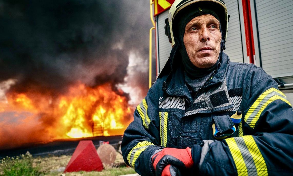 A firefighter standing in front of a fire

AI-generated content may be incorrect.