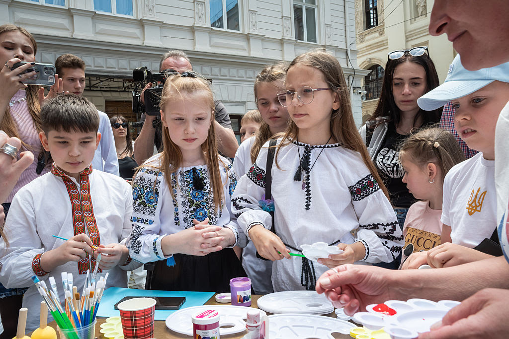 A group of children painting
AI-generated content may be incorrect.