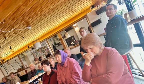 A group of people sitting at a table AI-generated content may be incorrect.