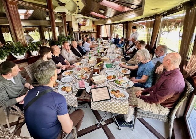 A group of people sitting at a table

AI-generated content may be incorrect.