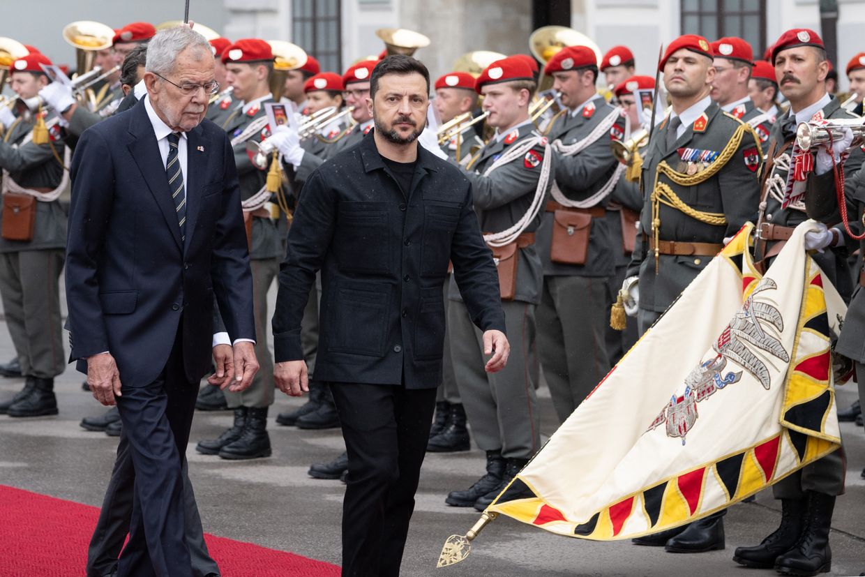 A person walking with a flag in front of a group of men

AI-generated content may be incorrect.