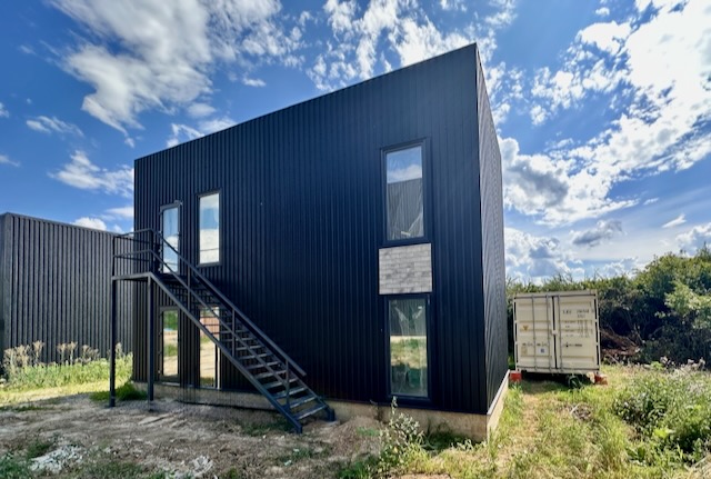 A black building with a staircase

AI-generated content may be incorrect.