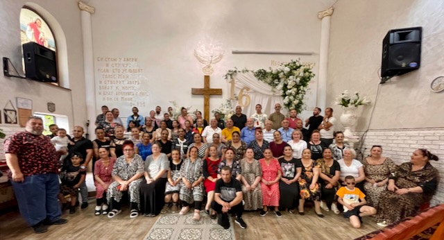 A group of people posing for a photo AI-generated content may be incorrect.