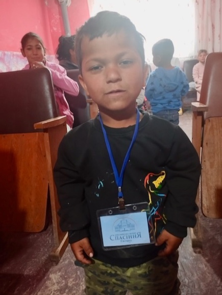 A young child wearing a badge AI-generated content may be incorrect.