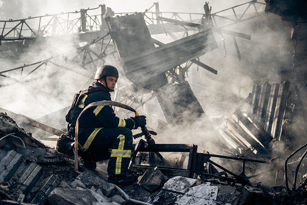 A firefighter sitting on a pile of debris

AI-generated content may be incorrect.