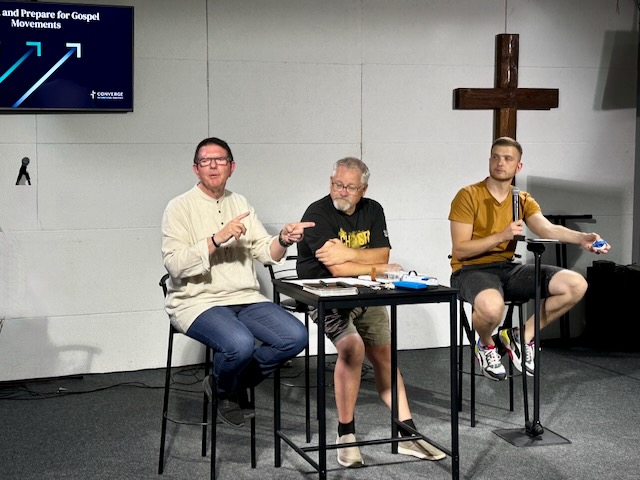 A group of men sitting at a table

AI-generated content may be incorrect.