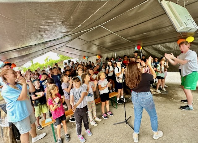 A group of people standing under a tent AI-generated content may be incorrect.