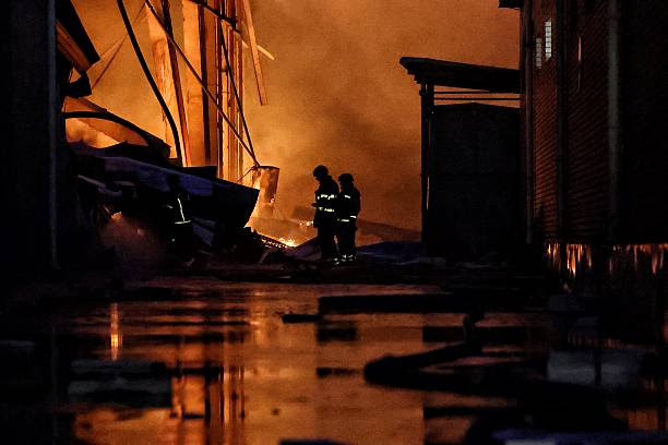 A fire fighters standing in front of a building

AI-generated content may be incorrect.