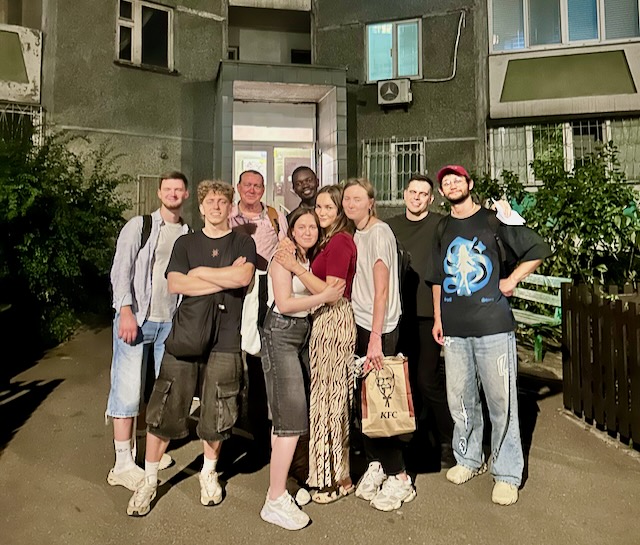 A group of people posing for a photo AI-generated content may be incorrect.