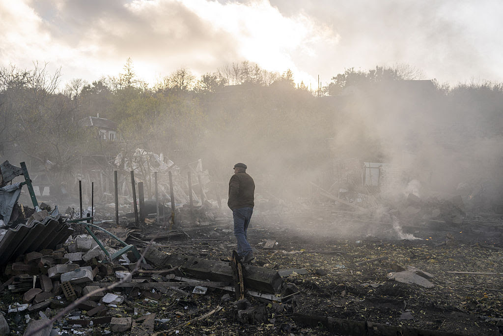 A person standing in a pile of debris

AI-generated content may be incorrect.