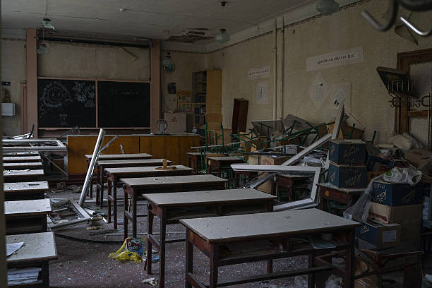 A room with broken desks and broken windows

AI-generated content may be incorrect.