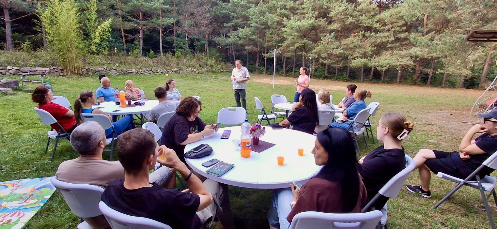 A group of people sitting around a round table

AI-generated content may be incorrect.