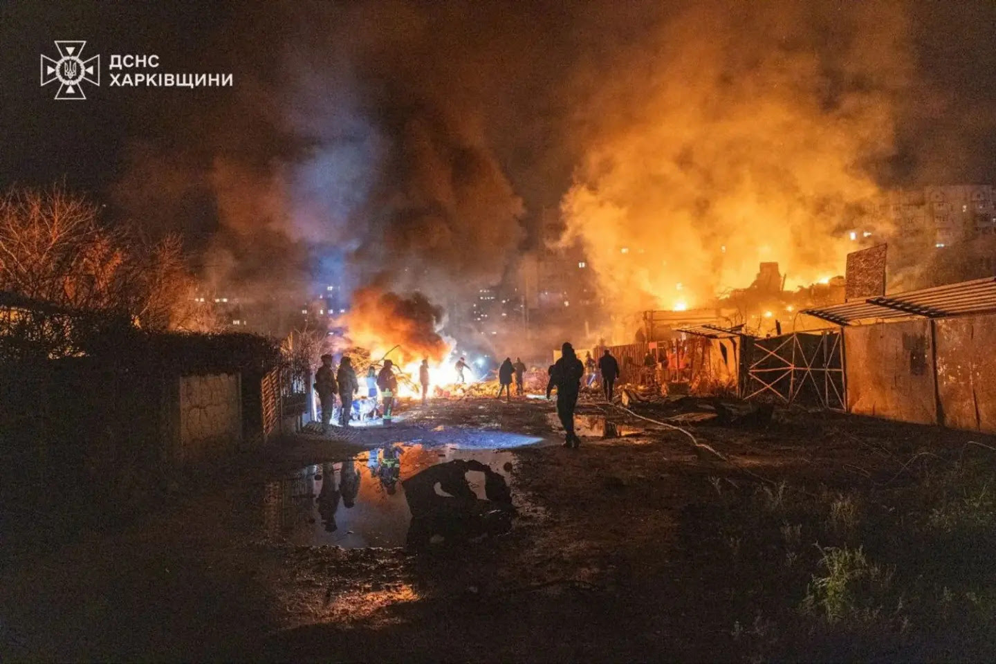 A group of people standing around a fire

AI-generated content may be incorrect.