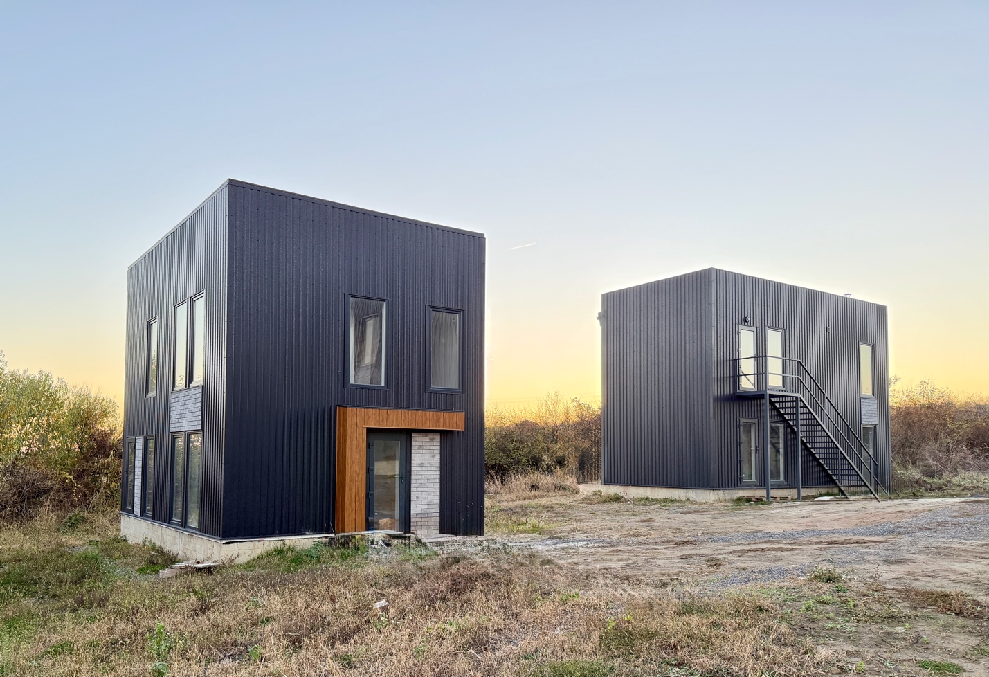 Two black houses with stairs and a staircase

AI-generated content may be incorrect.