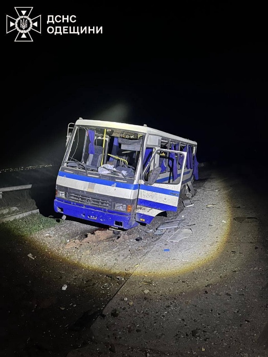 A bus damaged in a missile attack, with all its glass shattered.